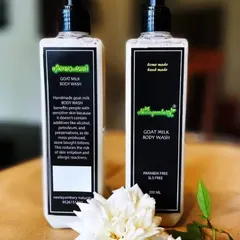 Our Goat Milk Body Wash, standing proud. It's handmade and free from SLS and parabens. The label explains how it benefits sensitive skin because it doesn't contain harsh additives like store-bought lotions.