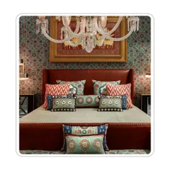 A bedroom that fully embraces the 'more is more' philosophy. The walls, bedding, and cushions are all layered with different patterns and textures, creating a rich, maximalist space that feels curated and personal.
