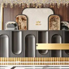 A detailed view of the uniquely designed reception desk, featuring curved grey panels and a striking gold-fluted base.