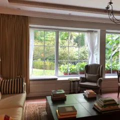 The sitting area for the Chairman's office in this international firm was designed to merge indoor comfort with outdoor serenity. Expansive windows frame the lush garden, maximizing natural light and creating a calm, inspiring environment for strategic thinking and relaxation.
