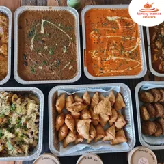Our party packs can include a mix of appetizers and main courses. This delivery featured Dal Makhani, a rich paneer curry, mini samosas, and kebabs, complete with chutneys and dips.