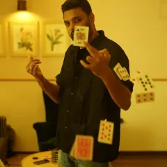 This shot captures the dynamic energy of my card magic. My style is all about creating moments of pure illusion and wonder, right in front of your eyes. It’s not about stage tricks, but about making the impossible happen in your hands.