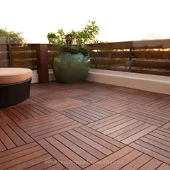 A stylish patio floor made from interlocking wooden deck tiles. This modular system is a versatile and attractive option for covering concrete balconies, patios, or rooftops.