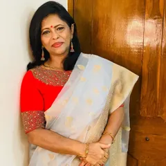 A light grey organza saree with gold leaf butis. I paired it with a vibrant red blouse to create a stunning contrast that is both modern and festive.