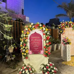A custom welcome sign for a Maa Bhagwati Jagran, framed by a vibrant arch of multi colored flowers. This is how we greet your guests and set a festive, devotional tone from the very beginning.
