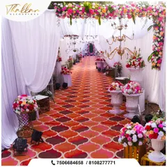 A grand wedding requires a grand entrance. This long, patterned aisle is flanked by floral arrangements and chandeliers, leading guests through a beautiful passage of white drapes.