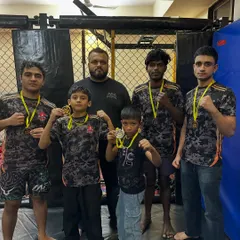 Standing with my team of champions after a weekend of dominant performances. My guidance helps them translate raw talent into medals.
