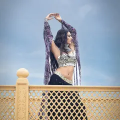A dramatic shot against the sky, capturing a sense of freedom and movement in this beautiful ensemble by Sajeda Lehry.