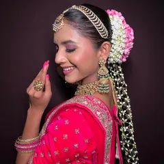 A side profile highlighting a long, decorated braid, showing how to incorporate hair accessories and flowers seamlessly.