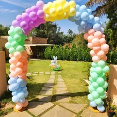 Make a colorful first impression with a rainbow pastel balloon arch. This makes a cheerful and welcoming entrance for an outdoor birthday party or Easter celebration.