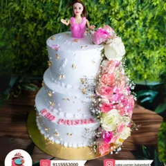 A stunning three-tier doll cake with a beautiful cascade of fresh pink and white roses. The gold leaf details add a touch of royal elegance for a princess's birthday.
