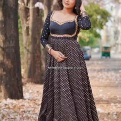 A full-length view of the black and gold Anarkali-style lehenga, showing its graceful flow and traditional border.