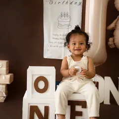 A classic teddy bear theme for this little one's first birthday portraits. The warm brown tones and adorable props create a timeless and cozy atmosphere.