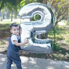 Two years old and full of smiles. I focus on making birthday milestone shoots fun and relaxed, letting your child's personality shine through. This outdoor portrait captures that wonderful, playful energy of being a toddler.