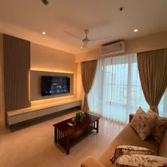 This TV unit is designed to be both stylish and functional. It features a floating console for a light feel, integrated backlighting for ambiance, and a fluted wood panel to add texture and architectural interest.