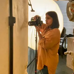 In my element, focused on getting the shot. This is a candid look at me working on set, carefully composing a shot and managing the light.