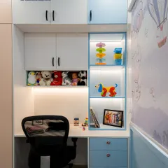 A perfect study and storage combination for a child's room in calming blue and white. The design includes open, backlit shelves for toys and a compact desk with drawers for supplies.