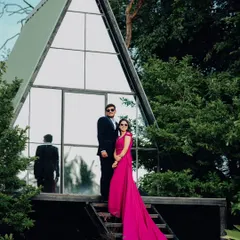 A full view of the dramatic gown and the sharp suit against the A-frame house. This setup is one of my most requested for couples wanting a modern and aspirational pre-wedding album.