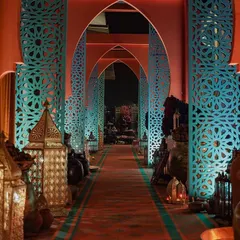 The entrance to our 'Moroccan Bazaar' event, featuring a long corridor of ornate, laser-cut arches and dozens of traditional lanterns. This dramatic entryway immediately transported guests into the world we created.