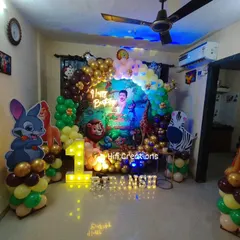 Here's how we transform a living room into a wild jungle adventure for a first birthday. This home setup includes a Lion King theme with a balloon arch, character standees, and a light-up number one.