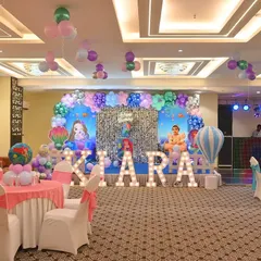 A wide-angle view of a banquet hall decorated for a Little Mermaid theme. We managed the main stage, guest table settings with themed centerpieces, and ceiling decorations.