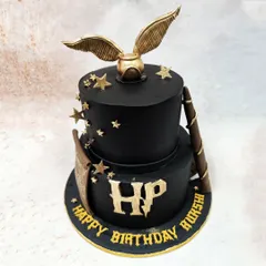 We capture the magic of the wizarding world with this two-tiered Harry Potter themed cake. The design features the iconic golden snitch, a wizard's wand, and the HP logo in gold against a stark black fondant, creating a sophisticated and spellbinding tribute for a fan's special day.