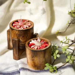 These wooden jar candles with red flower embeds bring a touch of nature indoors. The dark wood contrasts beautifully with the vibrant red flower, making it a cozy and stylish addition to any room.