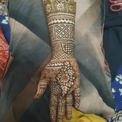 A single-arm design showcasing a lotus motif at the top. The rest of the arm is filled with bands of different geometric and traditional patterns, demonstrating precision and variety.