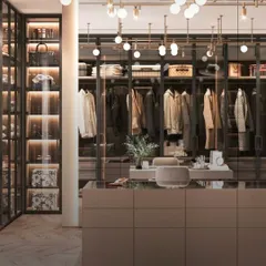 This is the dream walk-in closet, realized. We designed this space with a central island for accessories, glass-fronted displays for statement pieces, and custom lighting to create a boutique-like experience right in your home.