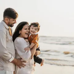 Nothing beats the pure, uninhibited laughter of a child playing with their parents. This shot from a first birthday celebration on a Mumbai beach uses the beautiful natural light to highlight a moment of genuine family fun.