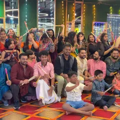 A happy group photo from a recent Garba workshop. You can see the mix of ages and the excitement as everyone holds their dandiya sticks, ready to dance.