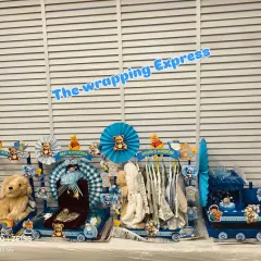 The complete 'Big Brother Express' gift train, featuring separate, themed carts for baby accessories, a personalized wardrobe, toys, and a special silver gift box.