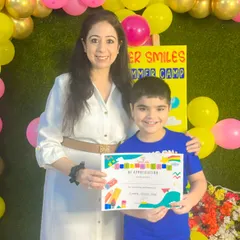 A big, bright smile from one of our happy campers. We believe in celebrating every child's effort and enthusiasm at the end of our summer program.