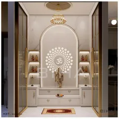 This pooja room design demonstrates our ability to create modern sacred spaces. We used white marble for its purity, framing an arched niche with soft, integrated lighting. The backlit 'Om' mandala creates a serene focal point, while glass doors with brass frames provide a sense of enclosure without sacrificing visual connection to the home.