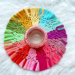 Another color variation of the macrame rangoli, this one with a pink macrame-wrapped candle holder in the center. The design is inspired by traditional rangoli patterns.