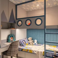 This angle shows how the bunk bed structure is integrated with the room's storage. The design ensures that every inch of space is used effectively, providing a comfortable sleeping area, a study zone, and ample wardrobe space in a compact footprint.