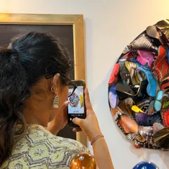 It is always a joy to see people interacting with my work. This visitor is capturing the intricate details of the butterfly wings.
