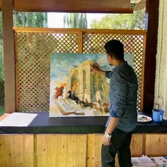 The large-scale historical painting, "Temple of Light: Martand’s Eternal Flame," nearing completion. The composition uses earthy and fiery tones to convey the tension and drama of the event.