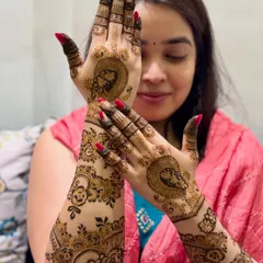 This lovely bride is showcasing her full-arm mehendi, which features portraits and floral patterns.