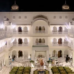 An epic wide shot showcasing the magnificent scale of Shikha and Rupen's wedding ceremony setup in the courtyard of a Jaipur palace.