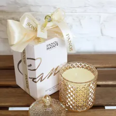 Our signature Crystal Cove candle, presented with its elegant gift box and Panos-branded ribbon. This makes for a perfect, ready-to-give luxury gift for any occasion.