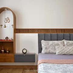 In this guest bedroom, we integrated a custom arched puja unit beside the bed. The design continues the fluted paneling detail from the headboard, creating a cohesive and sacred space.