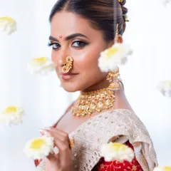 With every touch of our art, we awaken the Apsara within. A stunning portrait from a creative photoshoot with floating flowers.