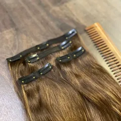 This is my go-to set of 4 clip-in extensions. You can see the secure clips and the healthy shine of the brown human hair, perfect for adding instant volume.