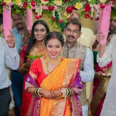 The grand entrance! This bride is absolutely glowing as she walks in for her wedding ceremony. Her makeup is traditional yet fresh, with a focus on radiant skin and a bright, happy smile.