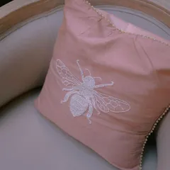 Details make the difference. For one wedding, we created custom upholstery with this beautiful hand-embroidered bee motif, adding a personal and whimsical touch to the decor.