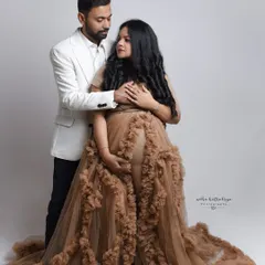 A full-length view of this gorgeous brown tulle gown against a clean, light background. I guide couples into poses that feel natural and loving, capturing the connection between them during this special time.