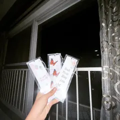 A nighttime shot of the custom bookmarks, showing how they catch the light. Each one is a small piece of art to mark your page.