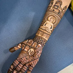 A close-up of the Jain Tapasya design, showing the central figure of a Tirthankara in meditation, with the client's initials 'NB' below.