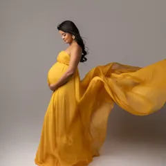 The vibrant yellow of this chiffon fabric catches the air beautifully, creating a dynamic shape that adds energy and joy to the portrait.